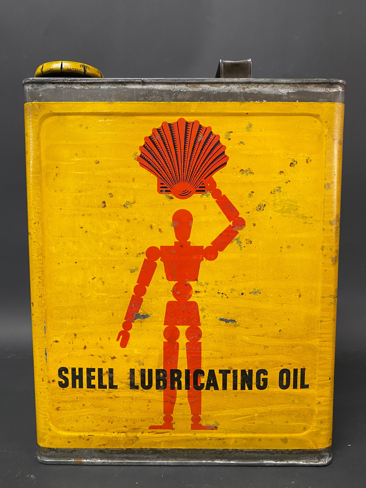 A Shell Lubricating Oil rectangular gallon can with robot/stick man motif, excellent condition.