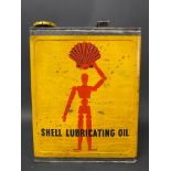 A Shell Lubricating Oil rectangular gallon can with robot/stick man motif, excellent condition.