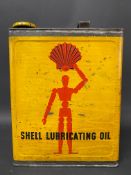 A Shell Lubricating Oil rectangular gallon can with robot/stick man motif, excellent condition.