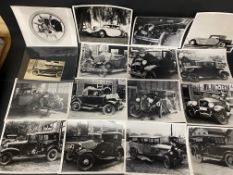 A selection of photographs, mostly of crash-damaged pre-war American cars, and mostly stamped to