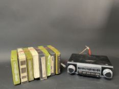 A Motorola radio, circa 1960s plus eight 8-track cassettes.