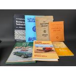 An MG Midget J Series Instruction Manual and six further motoring volumes.