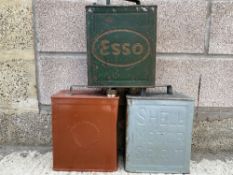 Two Shell two gallon petrol cans, and a third for Esso.
