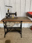 A Singer sewing machine as used by a car trimmer, complete with table and thread, model 31k47.