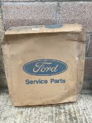 A new old stock Ford Escort radiator in original packaging.