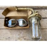 A boxed pair of Melton Mk. VIII goggles plus an exterior light from a garage.