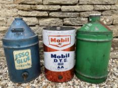 An Esso Blue five gallon drum, a Mobil drum and one other.