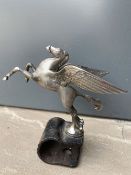 A Mobiloil Pegasus mascot, in the form of a winged horse, badge bar attachment.