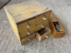 A small pine six drawer chest and a box of dies.