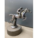A well detailed accessory mascot in the form of a horse and jockey leaping, display base mounted.