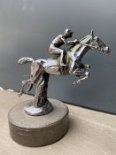 A well detailed accessory mascot in the form of a horse and jockey leaping, display base mounted.