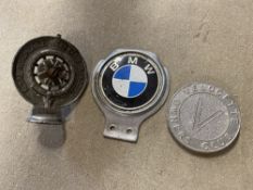 A Velocette Owners Club badge, a BMW car badge and an RAC Associate car badge.