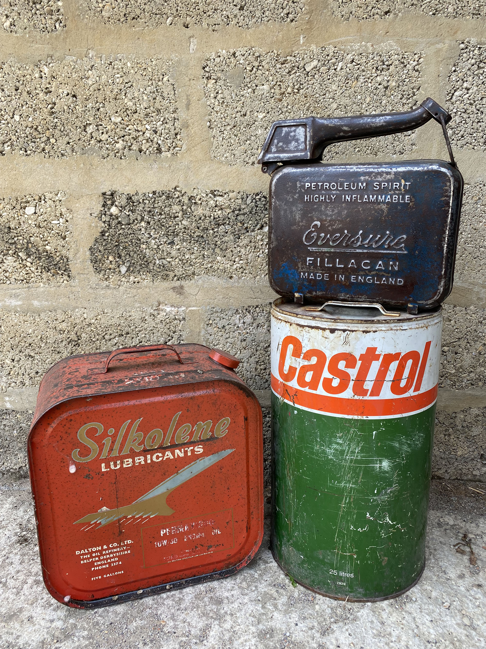 A Silkolene Lubricants five gallon can, a Castrol drum and an Eversure fuel can.