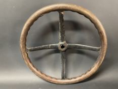 A veteran or Edwardian four spoke dished steering wheel with wooden rim, 17 1/2" w.