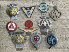 A selection of assorted car badges including British Field Sports Society, Aston Martin Owner's Club