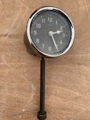 A 1930s 2" diameter 8-day car clock with long bottom wind.