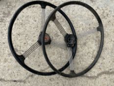 Two Morris 1000 three spoke steering wheels.