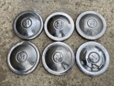 Six early Morris 1000 hub caps, marked with 'M' to the centres.