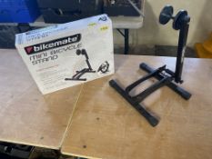 A boxed bikemate mini bicycle stand and one other.