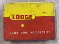 A Lodge Spark Plug Accessories tin with contents.