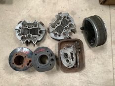 An autojumbler's lot of cylinder heads, cylinders, brake hub and parts.