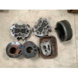 An autojumbler's lot of cylinder heads, cylinders, brake hub and parts.