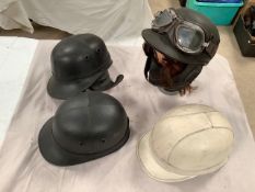 Four helmets, three being 'The Corker' by Compton and Webb Ltd