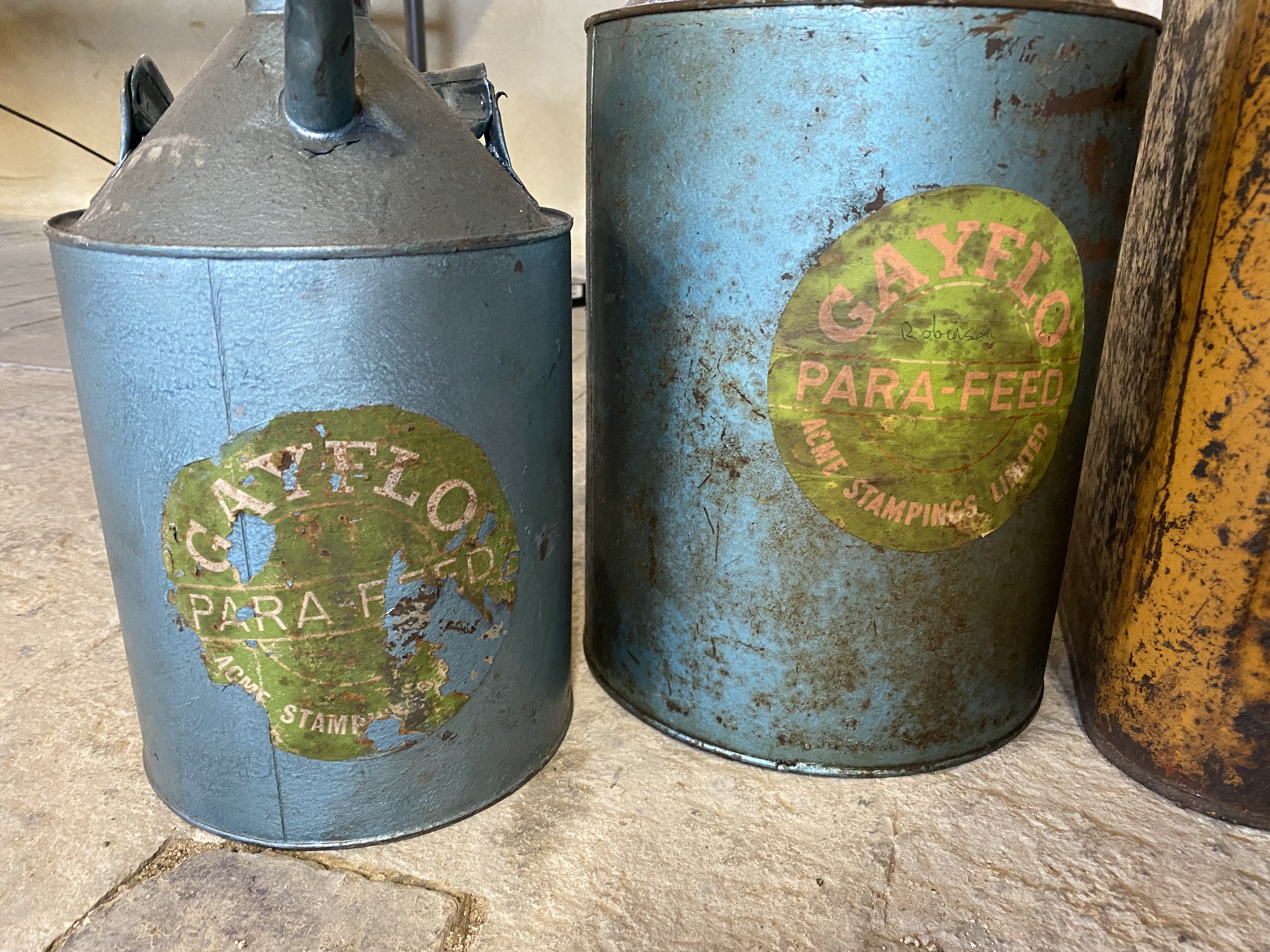 A Germ Oils five gallon pyramid can, two cans bearing labels for Gayflo Para-Feed, a petrol can. - Image 2 of 3