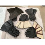 Five pairs of classic motorcycle gauntlets.