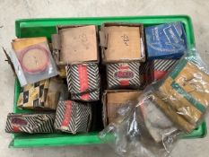 A box of new old stock piston rings, most in original packaging.