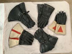 Five pairs of classic motorcycle gauntlets.