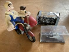 A contemporary and decorative model of Wallace and Grommit on a motorcycle plus two small models