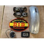 A selection of motorcycle parts including a Vincent Series C mudguard, a motorcycle tachometer