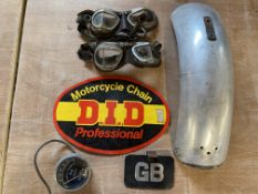 A selection of motorcycle parts including a Vincent Series C mudguard, a motorcycle tachometer