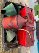 A box of petrol cans and oil measures.