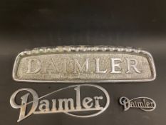 Three Daimler commercial vehicle name plaques.