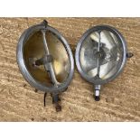 Two Marchal headlamps, one approx. 9" and the smaller approx. 8" diameter.