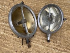 Two Marchal headlamps, one approx. 9" and the smaller approx. 8" diameter.