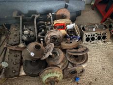 A collection of Ford V8 engine components, and various brake and other mechanical parts.