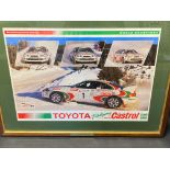 A framed and glazed World Championship Rally photograph signed by three drivers, all rallying with a