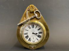 A Smith and Son brass framed travel car clock with key.