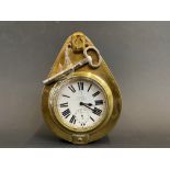 A Smith and Son brass framed travel car clock with key.