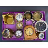 Two trays of car clocks and frames.