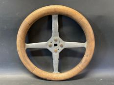 An Edwardian wooden rimmed four spoke steering wheel, overall 14 1/2" diameter.