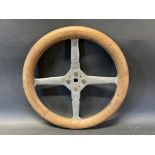 An Edwardian wooden rimmed four spoke steering wheel, overall 14 1/2" diameter.