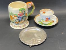 A Crown Devon musical jug depicting a couple on a tandem, a cup and saucer depicting cyclists and