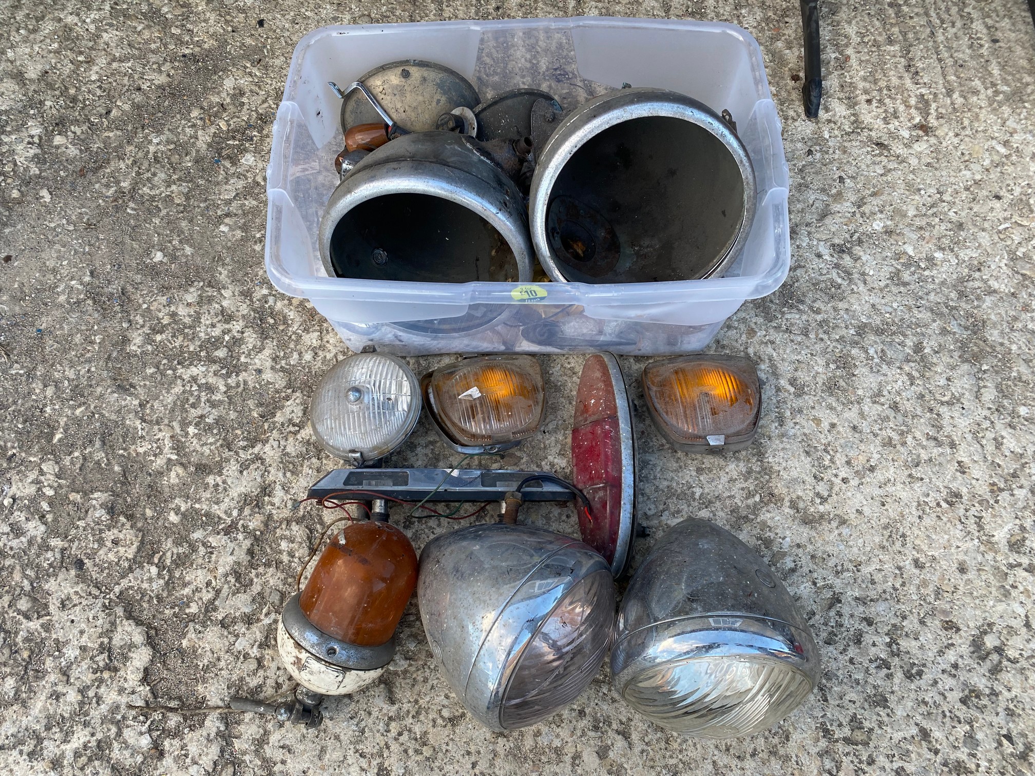 A selection of assorted headlamps and parts.