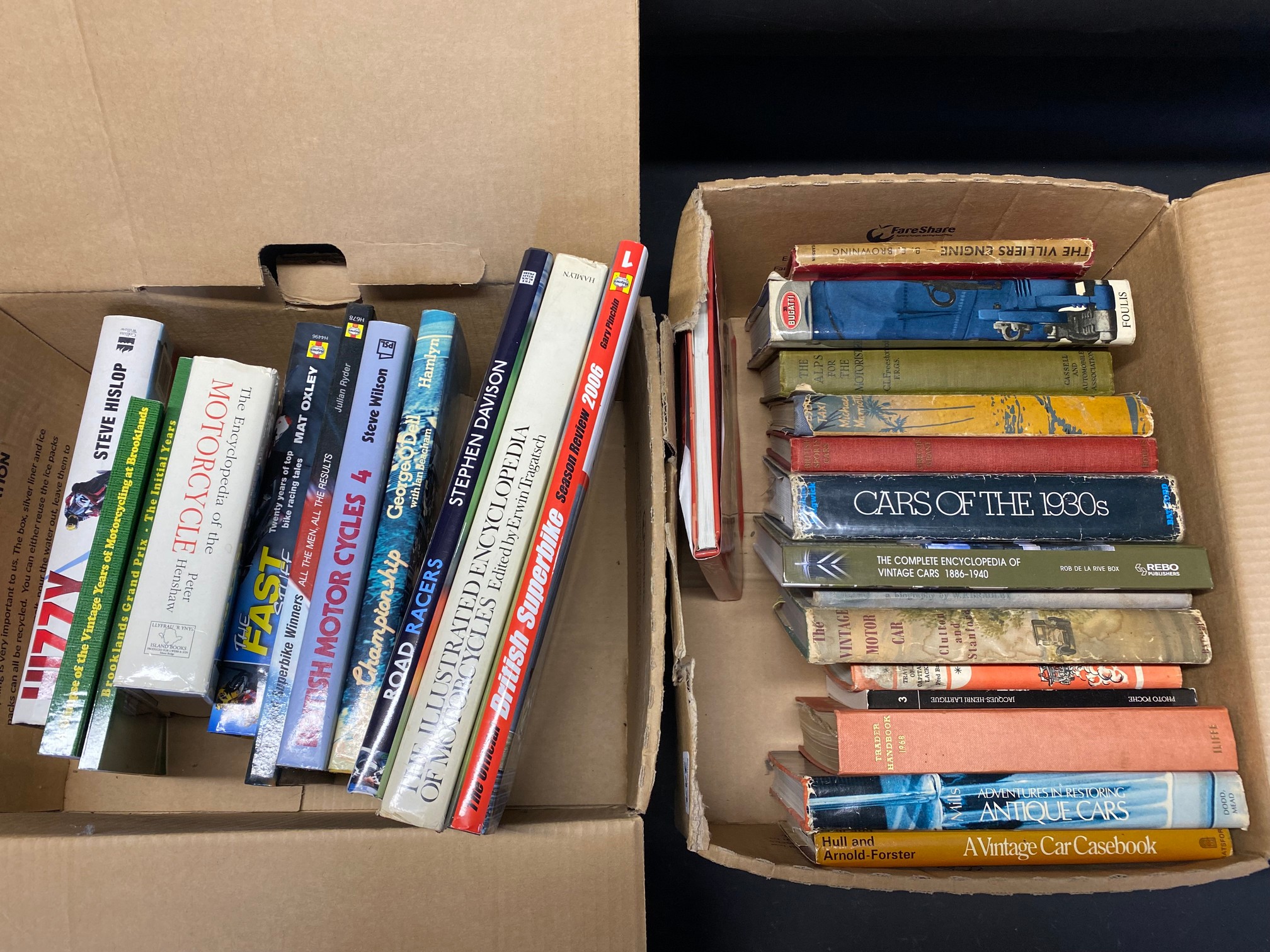 Two boxes of books on vintage cars and motorcycles.