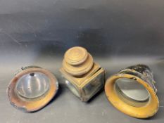 A pair of CAV bell-shaped headlamps plus an American brass paraffin lamp dated 1908.