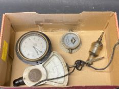 A Smiths eight day car clock, a voltmeter, an oil sight etc.